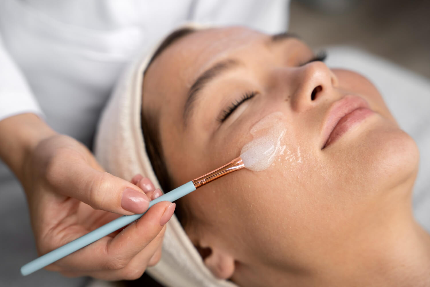 a woman getting a facial mask