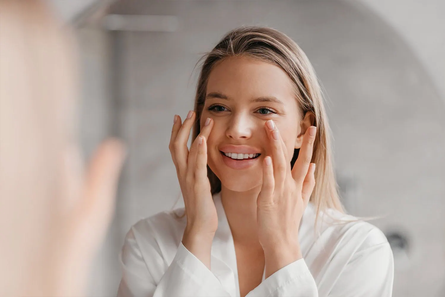 a woman touching her face, biostimulators-ar-aesthetics-in-melbourne-fl-two