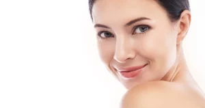 Young woman with dark hair, clear skin, and a friendly smile looking over her shoulder for Biostimulators in Tampa, FL.